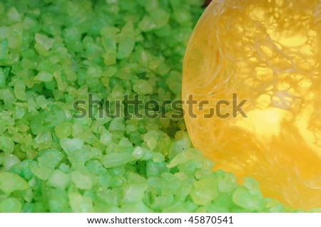 Green salt in transparent and scrubbing soap. Focus on soap. Shallow deep of focus.