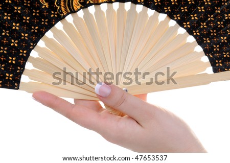 Female hands with nice french manicure and a decorated fan isolated on white background