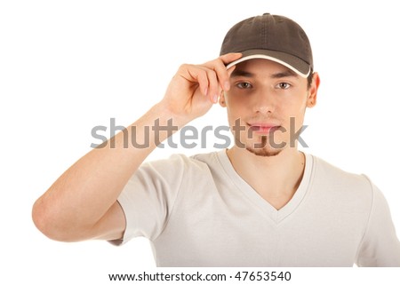 Serious young man in a brown hat is touching the hat peak