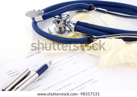 Form for medical examination with pen, gloves and stethoscope