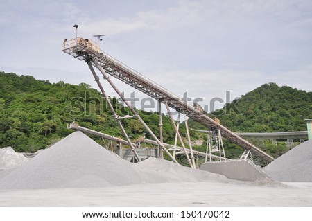 Conveyor belts with piles of gravel