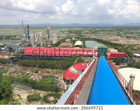 Cement factory in green field.