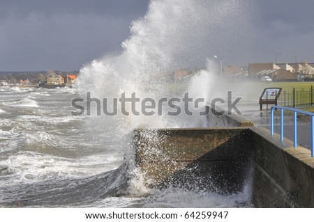 Waves breaking over sea wall 2