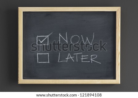Now and later check boxes written on a blackboard