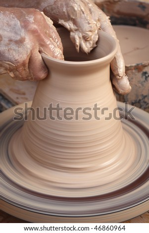 Potter at work. Close-up of potter turning a bowl on a potter\'s wheel