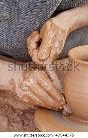 Potter at work. Close-up of potter turning a bowl on a potter's wheel