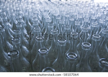 rows of empty bottles at bottling plant