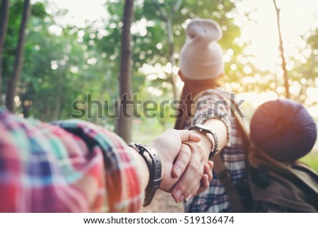 romantic adventure woman guiding man into the forest travel concept
