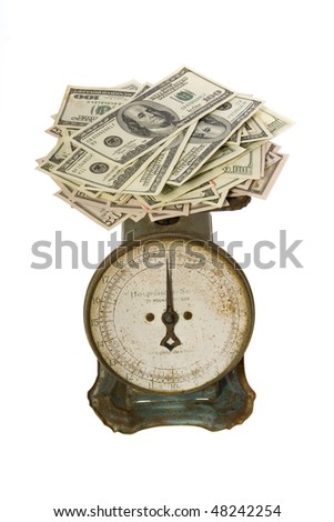 stock photo : US Currency One Hundred Dollar Bills arranged in a mess to weigh on an antique scale , isolated on white background.