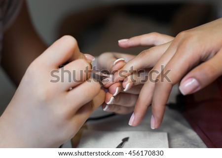 Nails saloon woman applying nail polish