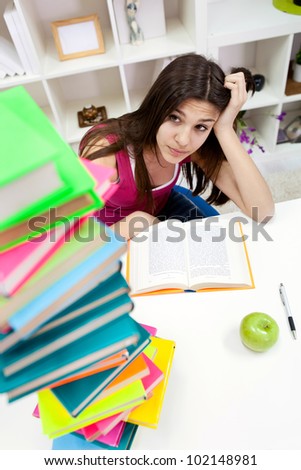 worried student girl looking in books