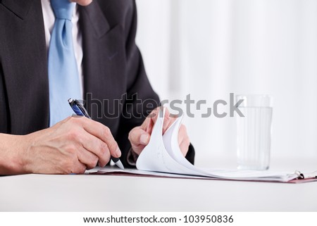 business man hand writing on paper Ã¢Â?Â? close up