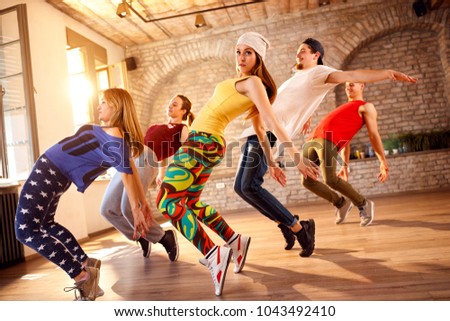 Group of dancers dancing together in dancing studio