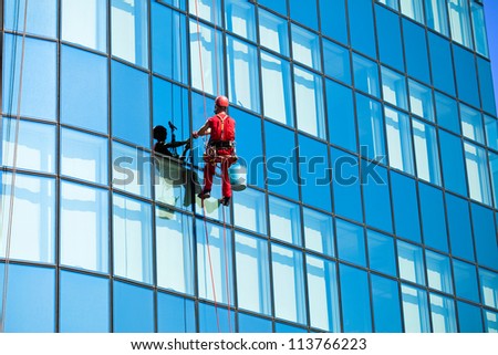 Washer wash the windows on  high office building