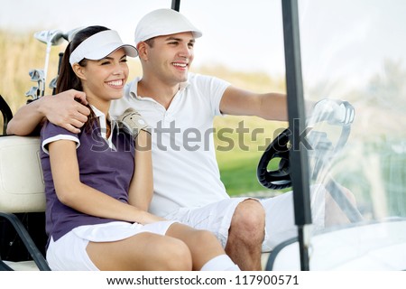 Golf couple driving in golf cart