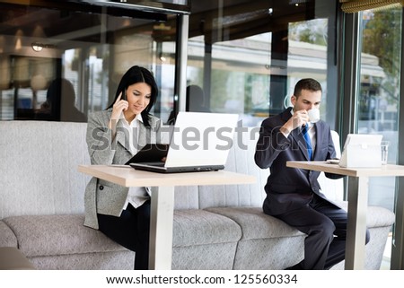 Busy business people in cafe, working while break