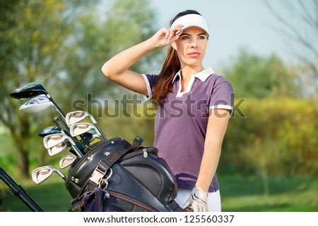 Beautiful woman golfer ready to play golf