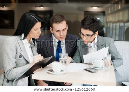 Young businesspeople having a business meeting at coffee table