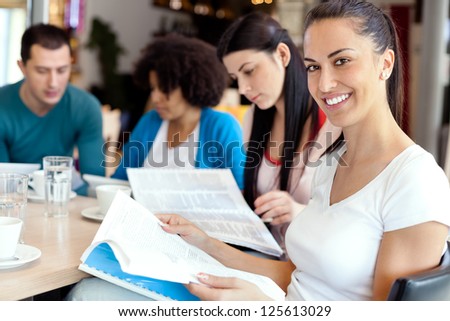 Young female student with friends on break at cafe Young female student with friends on break at cafe