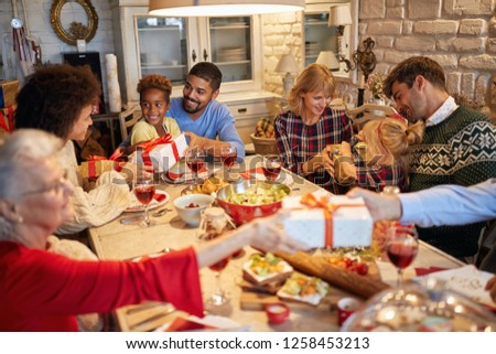 happy family and friends enjoy on Christmas dinner and exchange present together