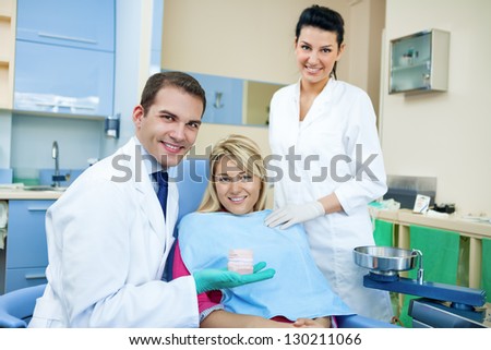 Dentist showing patient dental mold her teeth