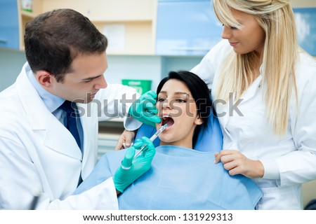 The dentist makes an injection at the clinic