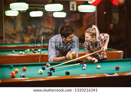 billiard game – smiling couple spending time together