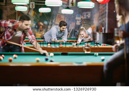 billiard games -Happy people enjoying playing pool together