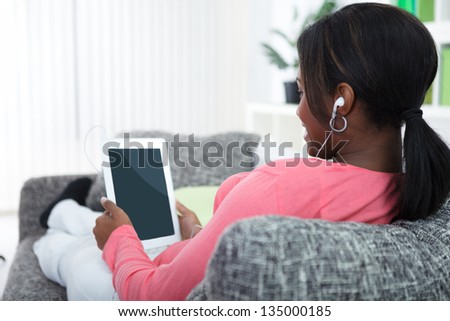 Black young woman relaxing with  digital tablet