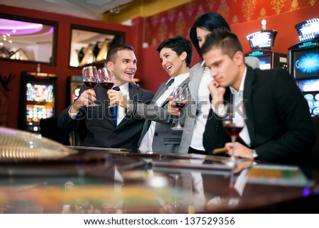 Excited couple and sad couple gambling in casino, bad luck