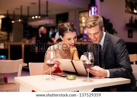 Couple Reading At Menu Together In A Restaurant