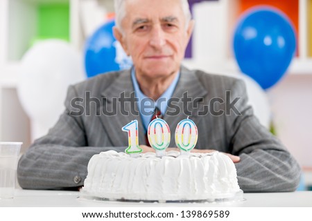 Senior man with cake on  one hundredth birthday