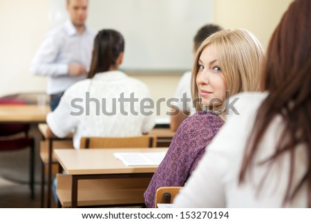 Young student girl on class, looking back