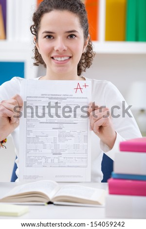 Teenager girl  holding test paper with the best result