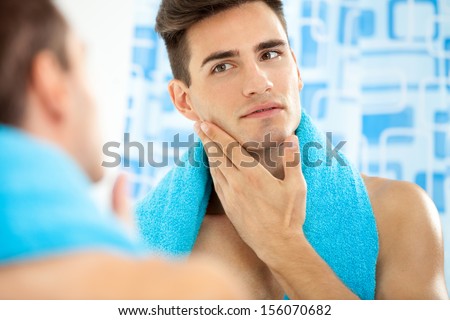Young Handsome Man Touching His Smooth Face After Shaving