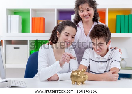 mother with her children putting money in piggybank, family saving