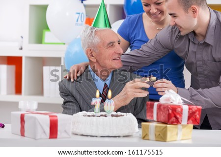 Family giving to father a present for his birthday