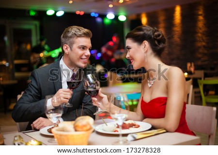 affectionate couple toasting at restaurant in romantic atmosphere