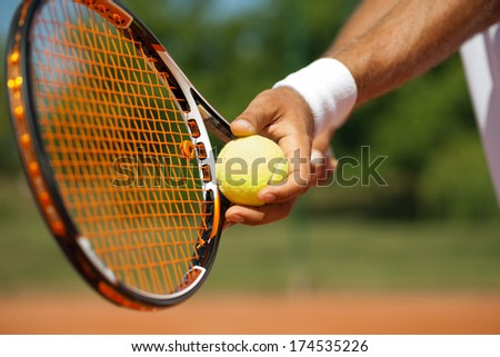 Close up of a tennis player standing ready for a serve