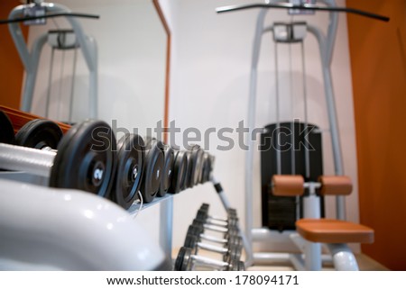 Weights, many black dumbbell in fitness room at gym
