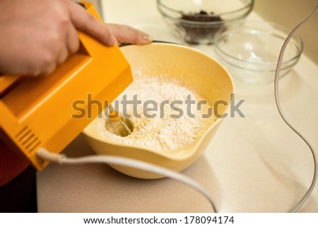 Whipping eggs and sugar in a bowl to make a cake mixture