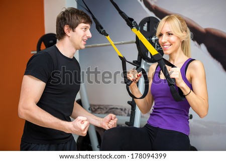 Sportswoman exercising with a resistance band at gym