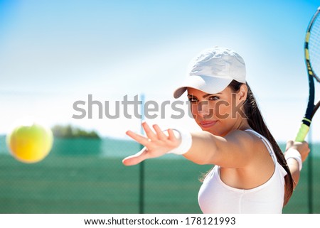 young female tennis player ready to hit ball