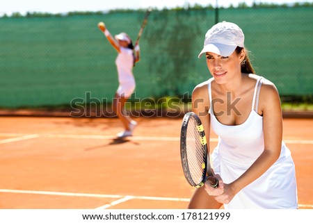 two tennis player playing doubles at tennis court