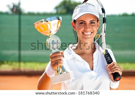 Female tennis player won the cup at the sport competition, prize and victory