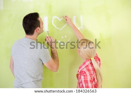 Love couple painting together their home
