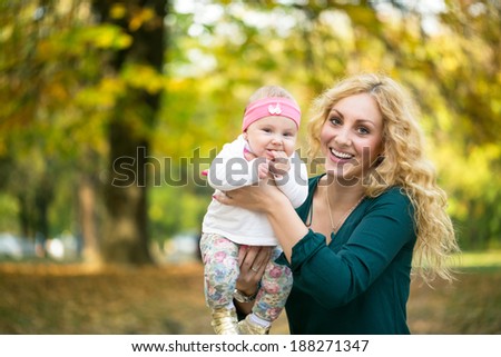 Lovely family, young mother with baby in park
