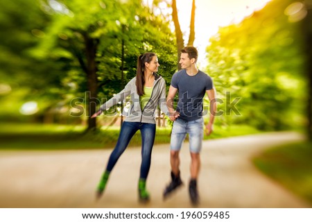 young happy roller couple in park,  time for roller blades - shoot with lensbaby
