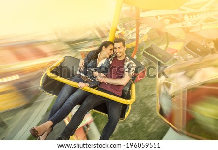 Happiness couple riding on ferris wheel at amusement park