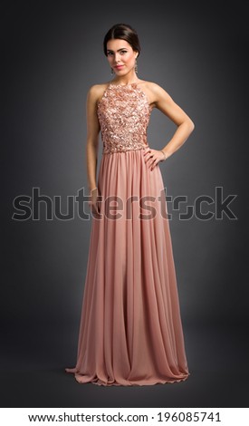 Charming young woman posing in luxury dress
